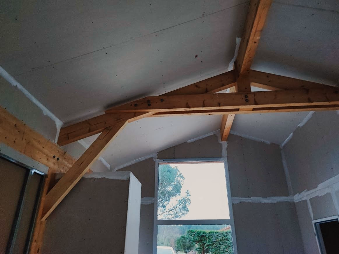 Intérieur de maison à Vielle-Saint-Girons avec plâtrerie terminée et charpente apparente